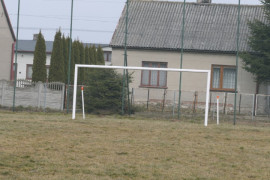 Boisko sportowe. Widoczna murawa i bramka 