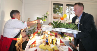 Mężczyzna wręcza kobiecie prymulkę (kwiatek w doniczce)