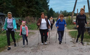 Grupa osób podczas marszu z kijkami Nordic Walking 