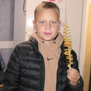 Chłopiec trzymający w ręku zakręconą frytkę 