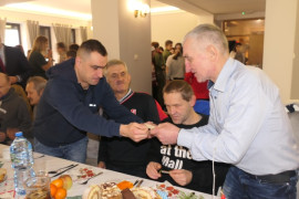 Mężczyźni podczas łamania się opłatkiem