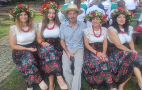 Kobiety w ludowych strojach i mężczyzna w kapeluszu 