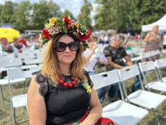 Kobieta w ludowym stroju i w wianku na głowie 