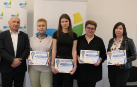 Cztery kobiety i mężczyzna stoją obok siebie. Kobiety trzymają w ręku dyplomy