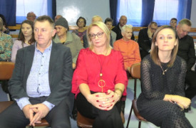 Grupa osób siedząca obok siebie 