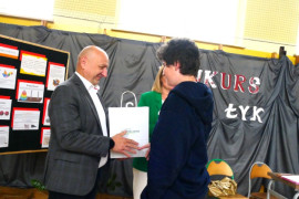 Chłopiec odbiera gratulacje od mężczyzny 