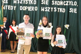 Uczniowie trzymają w dłoniach dyplomy