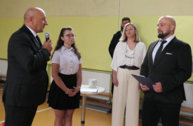 Dorosłe osoby i dziewczynka. Moment wręczania nominacji